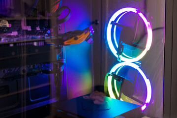Studio shot of black Gaming desktop pc with rgb lights and visible components. Isolated on white background.
