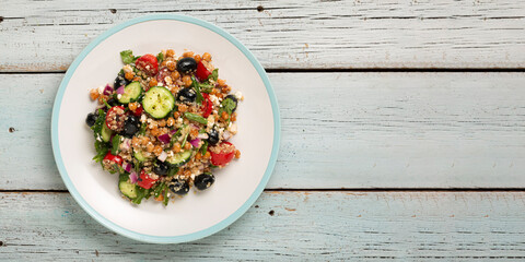 Vegetarian salad tomatoes, cucumbers, chickpeas, olives, herbs, cottage cheese, top view