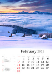 Calendar February 2021, vertical B3 size. Set of calendars with amazing landscapes. Incredible winter view of mountain village. Dramatic sunrise in Carpathian mountains, Ukraine, Europe..
