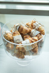 Fresh baked mini croissants in glass bowl