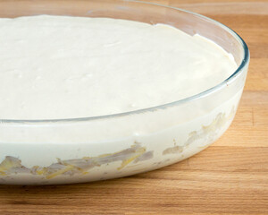 Raw pie with dough and meat filling on the table. No people