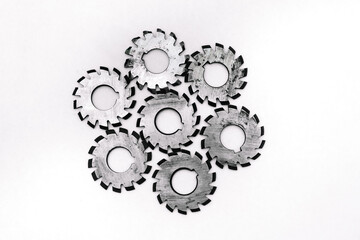 Several metal milling disc cutters for industrial equipment. The tool is isolated on a white background. Close-up