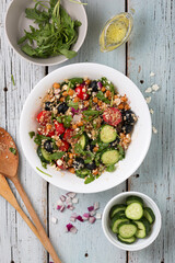 Vegetarian salad tomatoes, cucumbers, chickpeas, olives, herbs, cottage cheese, top view