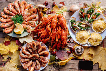 Shrimps, mussels, crayfish and scallops on wooden table