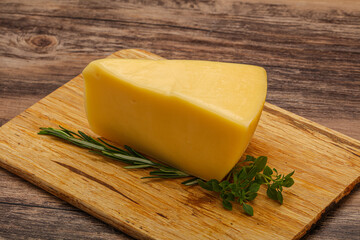 Hard cheese piece served rosemary