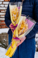 Two small bouquet of yellow dried plants in package