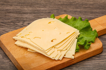 Sliced yellow cheese over board