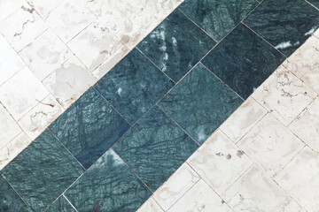 Mosaic stone floor tiling with green marble stripe
