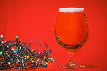 Tulip glass of beer with christmas lights