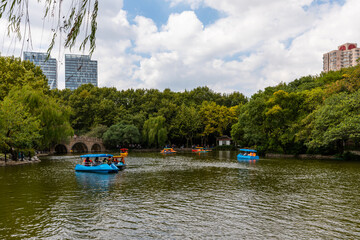 Fun with electric boats during National Day holidays on the lake at Luxun Park, Hongkou, Shanghai, China.