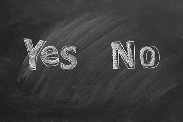 YES and NO text written in chalk on a blackboard. Your choice concept.