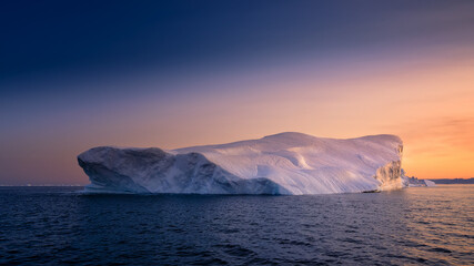 floating glaciers in the rays of the setting sun at polar night