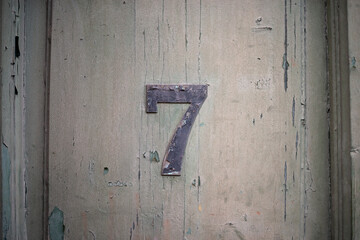 Lucky number seven on a grudge dark wooden wall