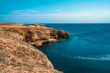 Black sea coastline with cliffs, rocks, turquoise waves and sea foam. Breathtaking, scenery landscape in Crimea