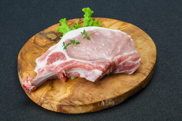 Raw pork bone steak over wooden