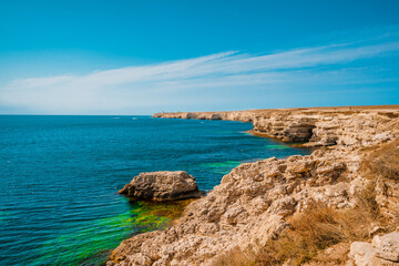 Fototapeta na wymiar Beautiful sea coast with turquoise water and rocks in Atlesh(Tarkhankut) region, Crimea. Summer seascape, famous travel destination