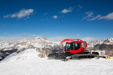 Red snowcat ratrack mountain panorama