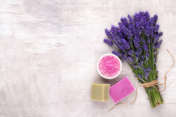 Grooming products and fresh lavender bouquet on white wooden table background.