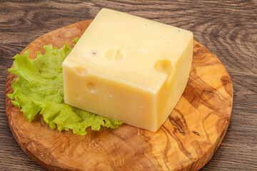 Emmental cheese over wooden board
