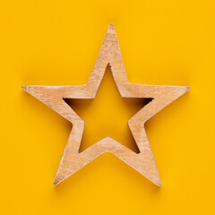 Christmas star decor on yellow colored background.