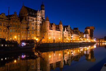 Fototapeta na wymiar Nightlife of illuminated embankment of Motlawa river in Gdansk in summer, Poland.
