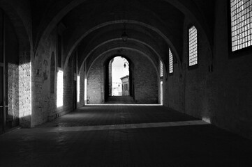Games of light that filters through the windows inside the Palazzo Ducale in Gubbio (Umbria, Italy, Europe) - 384778182