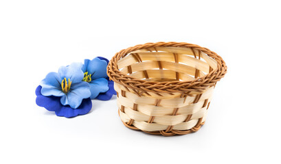 Banner wicker basket of decorative blue flowers, harvesting composition, on white isolated background