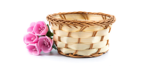 Banner composition with wicker basket and decorative pink flowers, on white isolated background