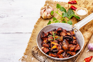 Ready to eat hot fried brown champignons in vintage pan