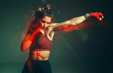 Close portrait of a female mixed martial arts fighter with a bandage on her hands. Long exposure...
