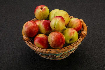Sweet small nectarines in the basket