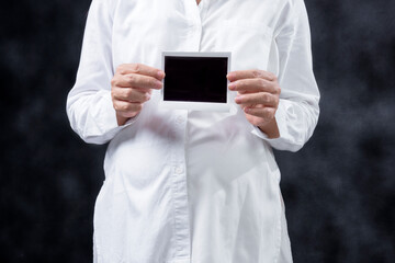 Pregnant woman holding ultrasound pregnancy test result