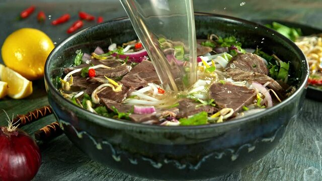 Super Slow Motion Shot of Pouring Beef Broth into Pho Soup at 1000 fps.