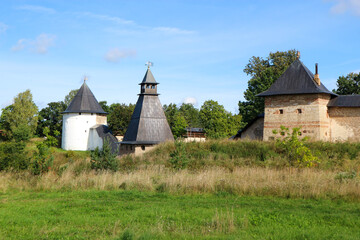 the tops of the fortress wall towers of Pskov-Pechory Dormition Monastery in Pechory, Pskov region, Russia under blue sky