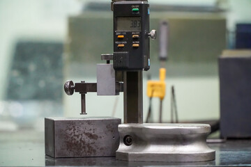 Caliper height gauge on surface plate and measure the product size on surface magnet, Tool for Inspection product in engineering lab, Digital system	