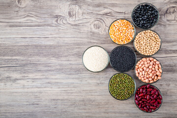 Cereal grains seeds beans on wooden background. Whole grains and bean. Cereals and beans. Different dry legumes for eating healthy. Peanut , Black bean, Red Bean. Green Bean, Soybean, sesame