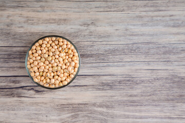 Soybean or soya bean in a bowl on wooden background. Soybean organic background.
