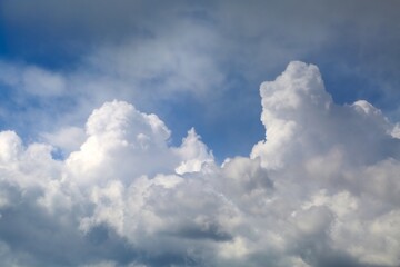 Naklejka na ściany i meble Stormy clouds in the blue sky gathering befor thunderstorm