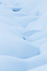 Obraz premium beautiful smooth lines texture of snowdrifts play of light and shadow of a winter landscape on the background