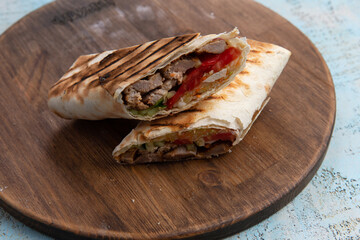 Shawarma sandwich gyro fresh roll of lavash. pita bread. chicken beef shawarma falafel RecipeTin Eatsfilled with grilled meat, mushrooms, cheese.