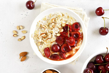 Porridge with cherry slices and nuts in bowl