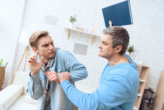 Father Intimidates His Son With Book,