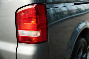 Close up headlights of car. Black premium city crossover, luxury SUV rear light closeup. Car lamp close up.