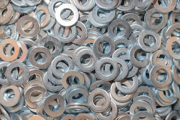 Washers for the bolt. Texture. Many washers for bolts and screws. Background for wallpaper. Shim. Spacer.