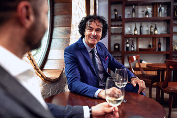 Business partners enjoying a glass of wine