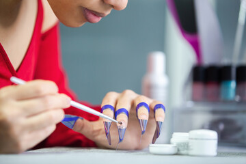 Woman applying nail builder gel. nail extension sticker.