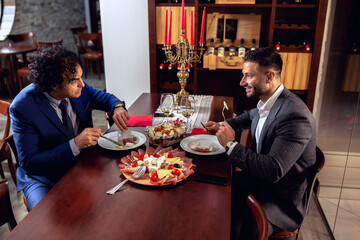 Fototapeta na wymiar Two businessmen having a meal and some wine
