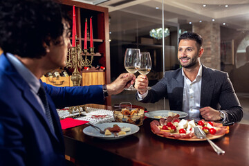 Two serious businessmen enjoying a meal