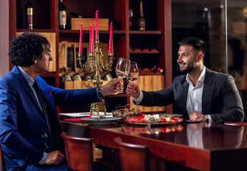 Two businessmen raising their glasses