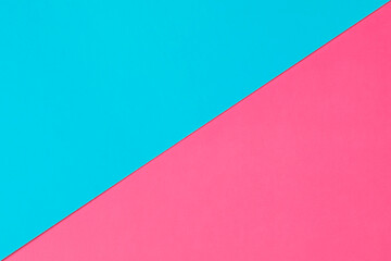 Blue and pink sheets of cardboard with a diagonal seam line for gender design. Copy space